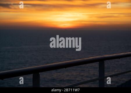 Railing of a cruise ship in the sunset Stock Photo