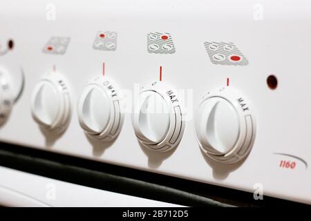 Knobs on a white electric stove closeup Stock Photo