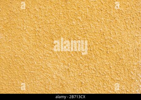 the texture of the wall is made of old yellow plaster Stock Photo