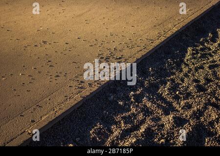 scattered gravel granite on the roadside surface texture Stock Photo