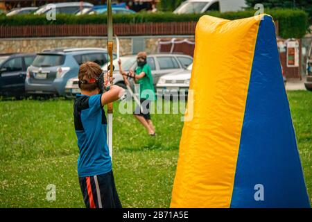 Boy attacking his opponent in a game of archery tag