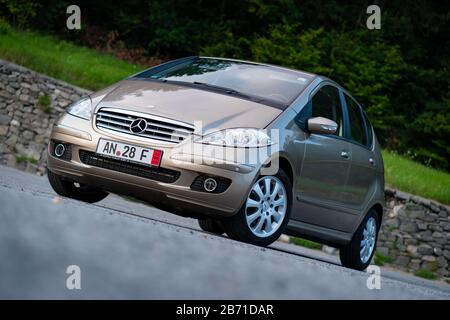 German sedan car, Mercedes Benz A class, type W203 isolated in an empty  parking lot - a sunny day. Isolated, empty parking lot Stock Photo - Alamy