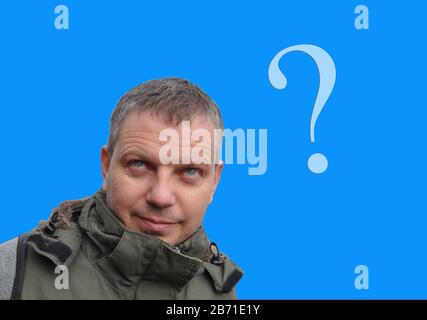 Thinking man on a blue background with a question mark. Think Stock Photo