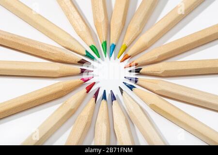 Colored pencils arranged in a circle. Back to school background. Top view Stock Photo