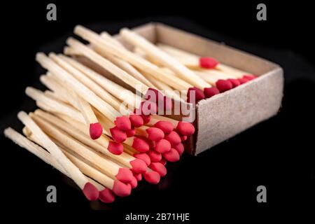 Matches in gray paper boxes. Wooden sticks with sulfur on the tip to ignite the flame. Dark background. Stock Photo