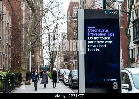 New York, USA. 12th Mar, 2020. An electronic billboard operated by the city of New York displays coronavirus prevention tips in near a school in the Upper East Side, in an effort to contain the spread of COVID-19. Credit: Enrique Shore/Alamy Live News Stock Photo