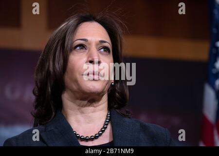 United States Senator Kamala Harris (Democrat of California) listens during a news conference at the United States Capitol in Washington, DC, U.S., on Thursday, March 12, 2020. Harris, along with United States Senator Kirsten Gillibrand (Democrat of New York) and United States Senator Cory Booker (Democrat of New Jersey), is working on legislation that would ensure paid sick leave to deal with the Coronavirus. Credit: Stefani Reynolds/CNP /MediaPunch Stock Photo