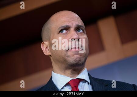 United States Senator Cory Booker (Democrat of New Jersey) listens during a news conference at the United States Capitol in Washington, DC, U.S., on Thursday, March 12, 2020. Booker, along with United States Senator Kirsten Gillibrand (Democrat of New York) and United States Senator Kamala Harris (Democrat of California), is working on legislation that would ensure paid sick leave to deal with the Coronavirus. Credit: Stefani Reynolds/CNP /MediaPunch Stock Photo