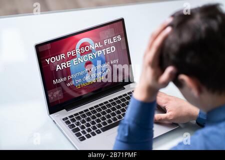 Close-up Of A Person Looking At Laptop Screen Showing Personal Files Encrypted Text Stock Photo