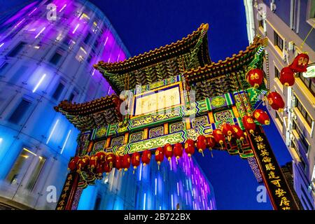 Colourful oriental style gate into Chinatown at night, London, UK Stock Photo