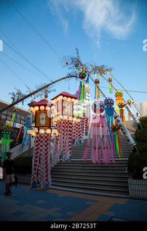 Aichi, JAPAN - August 6, 2016: Traditional japanese paper decoration on bamboo poles. Anjo Tanabata festival, Aichi, Japan., evening time in motiom bl Stock Photo