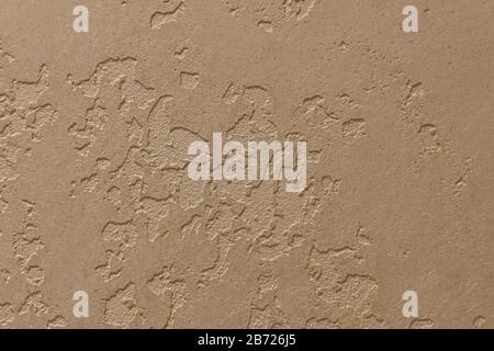 Light beige plaster on the wall applied by a hand spatula. Stock Photo