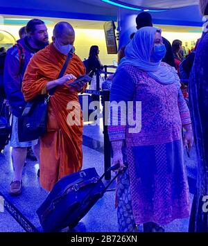 Chicago, Illinois, USA. 12th Mar, 2020. Some passengers arriving at Chicago's O'Hare International Airport from Paris March 12, 2020 wear masks because of the Coronavirus pandemic. They are shown in the immigration staging area. Credit: Mark Hertzberg/ZUMA Wire/Alamy Live News Stock Photo