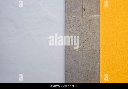 Wall panels in colors: yellow and gray, detail of modern house facade. Stock Photo