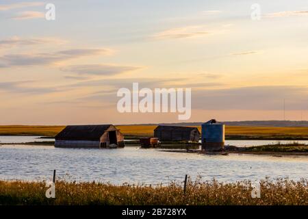 An old farm house and barn that were built by the early farming settlers of the Province of Saskatchewan in Canada. Stock Photo