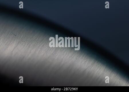 steel with a brushed finish against a dark background Stock Photo
