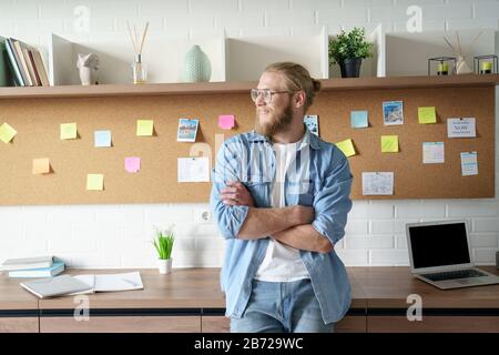 Young man work from home office stand lean table notes background copy space. Stock Photo