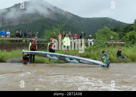 Durban, South Africa, people, events, two adult male competitors draining water from boat, 2020 Duzi Canoe Marathon, contains logos, sport, paddlers Stock Photo