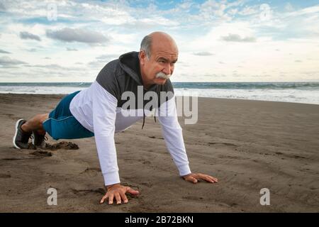 Active Senior Woman Running On The Beach. Stock Photo