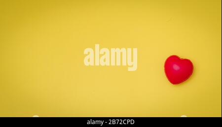 Red Heart on yellow paper card table top view background concept for Valentine day banner, mother day gift banner, happy birthday backdrop, greeting m Stock Photo