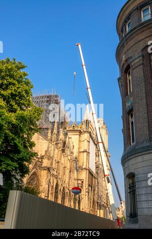France. Summer sunny day in Paris. Narrow street. Crane restores Notre Dame after 2019 fire Stock Photo