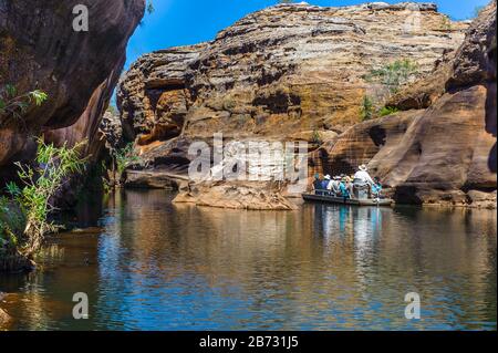 Cobbold Gorge tour guides steer boats up the steep sided geological formation in Western Queensland in Australia. Stock Photo