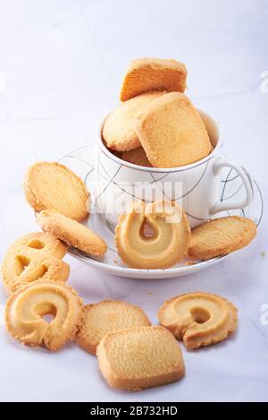 Set of coffee cups and a pile of cookies Stock Photo