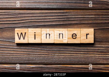 WINNER word written on wood block. WINNER text on wooden table for your desing, concept. Stock Photo