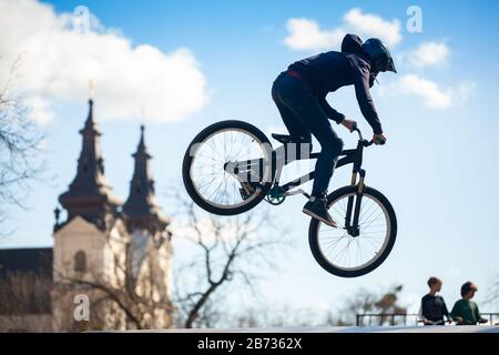 Young man doing tricks on a BMX bike. BMX freestyle against the