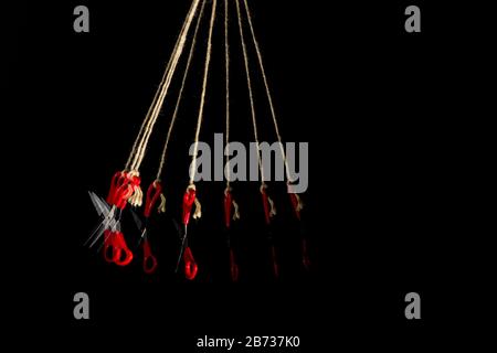 Scissors for manual work and school work, for cutting paper, cardboard, fabric, threads, twine; scissors hanging on string, multiple images of scissor Stock Photo