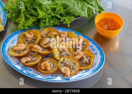 Plate of Vietnamese fried shrimp pancakes- Banh Khot Stock Photo