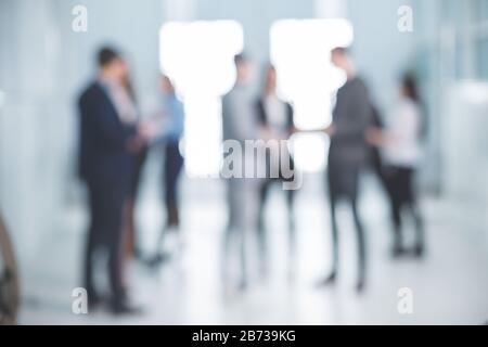 background image of a group of corporate employees in the office lobby Stock Photo