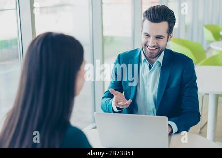 Photo of two workers having a meeting in restaurant and speaking about their new successful project. Stock Photo
