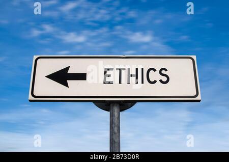 Ethics road sign, arrow on blue sky background. One way blank road sign with copy space. Arrow on a pole pointing in one direction. Stock Photo