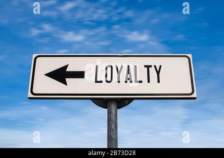 Loyalty road sign, arrow on blue sky background. One way blank road sign with copy space. Arrow on a pole pointing in one direction. Stock Photo