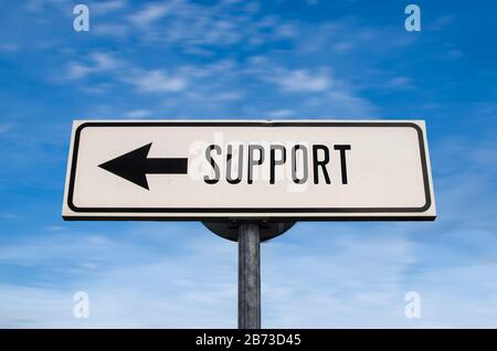 Support road sign, arrow on blue sky background. One way blank road sign with copy space. Arrow on a pole pointing in one direction. Stock Photo