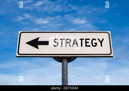 Strategy road sign, arrow on blue sky background. One way blank road sign with copy space. Arrow on a pole pointing in one direction. Stock Photo