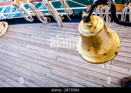 Golden bronze bell on the deck of a sailboat. Stock Photo