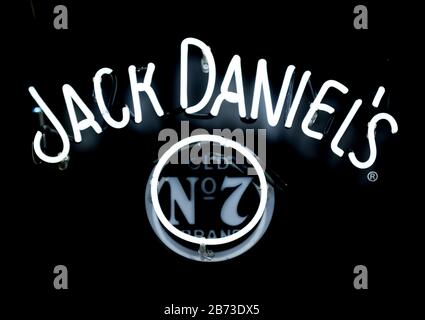 Close-up on a neon light shaped into Jack Daniel's logo. Stock Photo