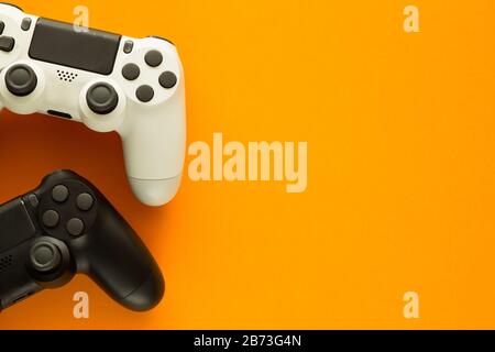 Stock photo of two gamepads on a yellow background and copy space on the right side Stock Photo