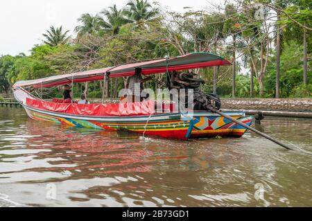 Colorful long tail boat sails in a canal in the center of Bangkok, Thailand, to make tourists take a tour of the city Stock Photo