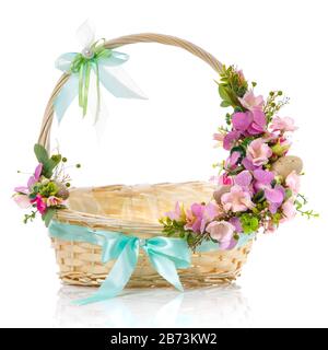 Easter baskets with delicate floral decor and decorative eggs isolated on a white background Stock Photo