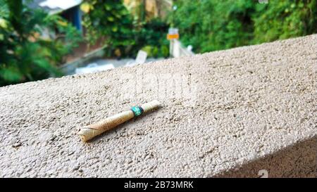 a cigarette twisted from a dry leaf. Time to rest. Stock Photo