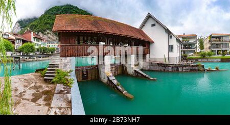 Panoramic view of weir on Aare river of Old City of Unterseen, Interlaken, important tourist center in the Bernese Highlands, Switzerland Stock Photo