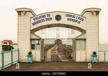 Entrance gate to Mumbles Pier (1898) and was formerly at the terminus of the Swansea and Mumbles Railway, Wales, UK. Stock Photo