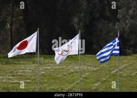 Ancient Olympia, Greece. 12th Mar, 2020. Flags of Japan (left) of Olympics (centre) and of Greece in ancient's Olympias stadium, Greece on March 12, 2020. (Photo by Dimitrios Karvountzis/Pacific Press/Sipa USA) Credit: Sipa USA/Alamy Live News Stock Photo