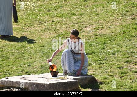 Ancient Olympia, Greece. 12th Mar, 2020. High Priestess Xanthi Georgiou is lighting the Olympic torch in ancient's Olympias stadium, Greece on March 12, 2020. (Photo by Dimitrios Karvountzis/Pacific Press/Sipa USA) Credit: Sipa USA/Alamy Live News Stock Photo