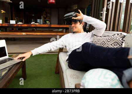 Man using virtual reality headset on a terrace Stock Photo