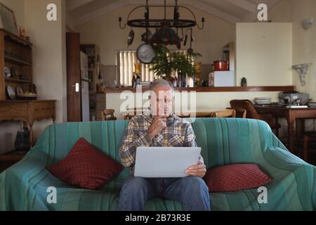 Senior man using laptop at home Stock Photo