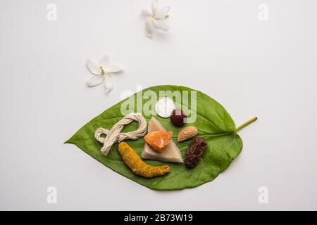 Hindu Puja with betel leaf, supari, janeu, almond, dates, turmeric ...